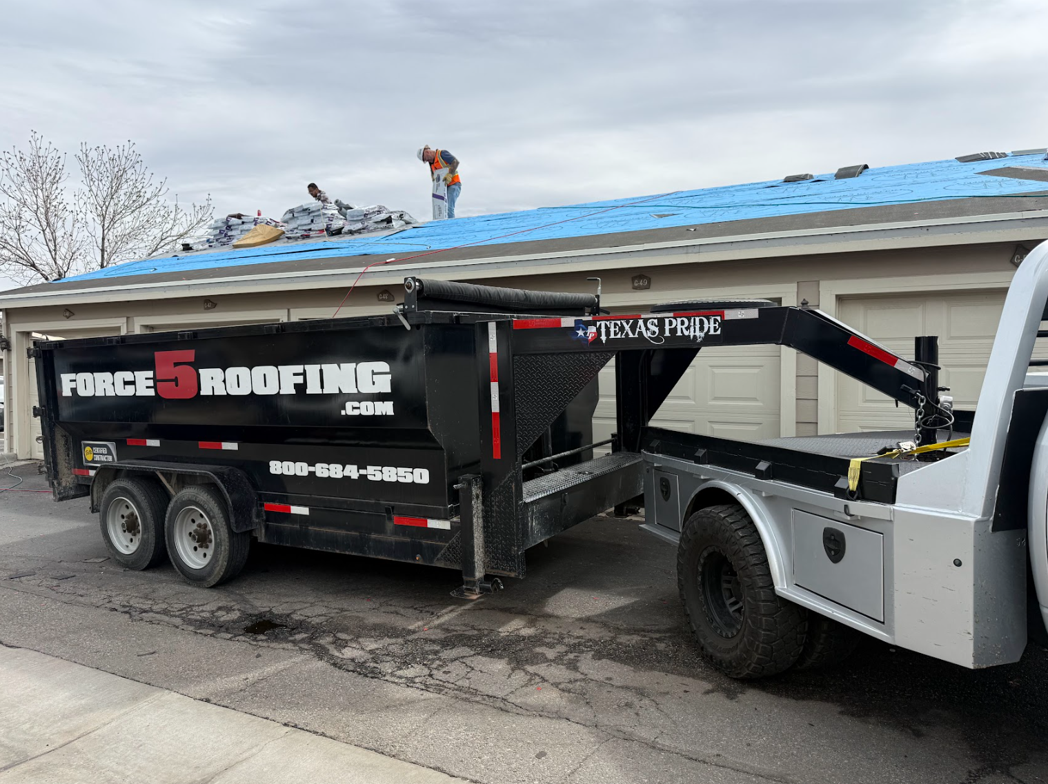 Force 5 Roofing branded truck and dump trailer parked at a Denver Metro job site